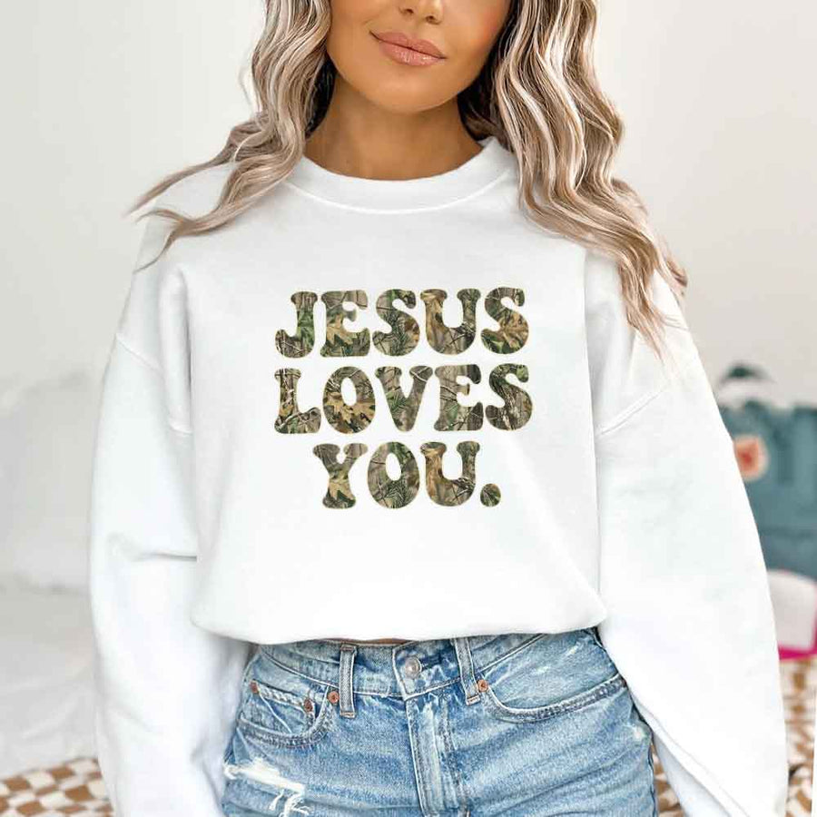 May include Jesus Loves You camouflage sweatshirt with Christian faith graphic design and relaxed unisex fit