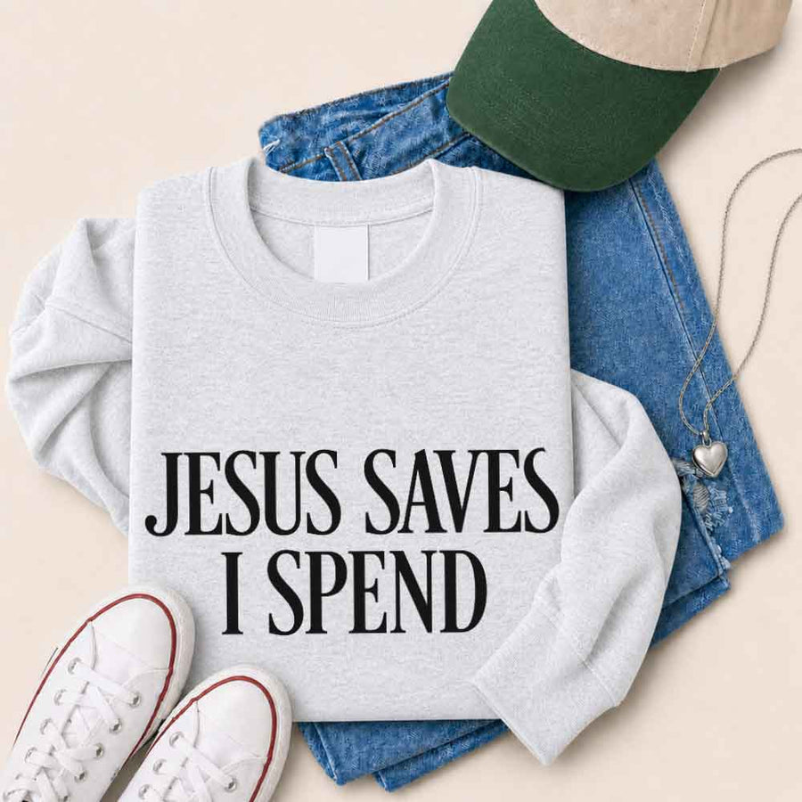 May include Jesus Saves I Spend sweatshirt with gospel inspired humor graphic design and relaxed unisex fit