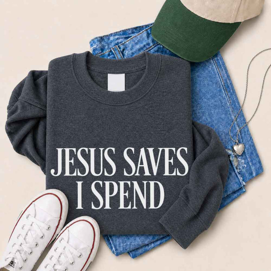 May include Jesus Saves I Spend sweatshirt with gospel inspired humor graphic design and relaxed unisex fit