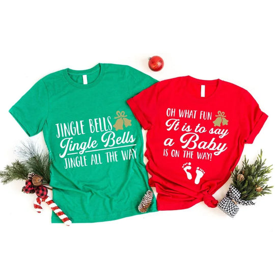 May include a set of matching Christmas-themed pregnancy announcement t-shirts for couples, featuring festive holiday designs and the phrase “Jingling All the Way to Parenthood.”