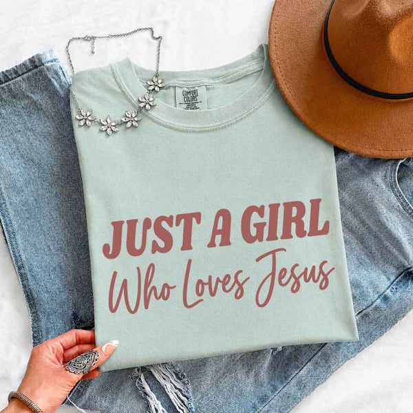 May include Just A Girl Who Loves Jesus Comfort Colors women’s faith graphic tee with relaxed fit design