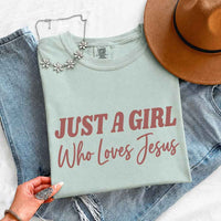 May include Just A Girl Who Loves Jesus Comfort Colors women’s faith graphic tee with relaxed fit design