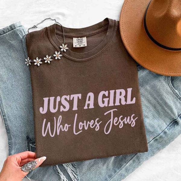 May include Just A Girl Who Loves Jesus Comfort Colors women’s faith graphic tee with relaxed fit design