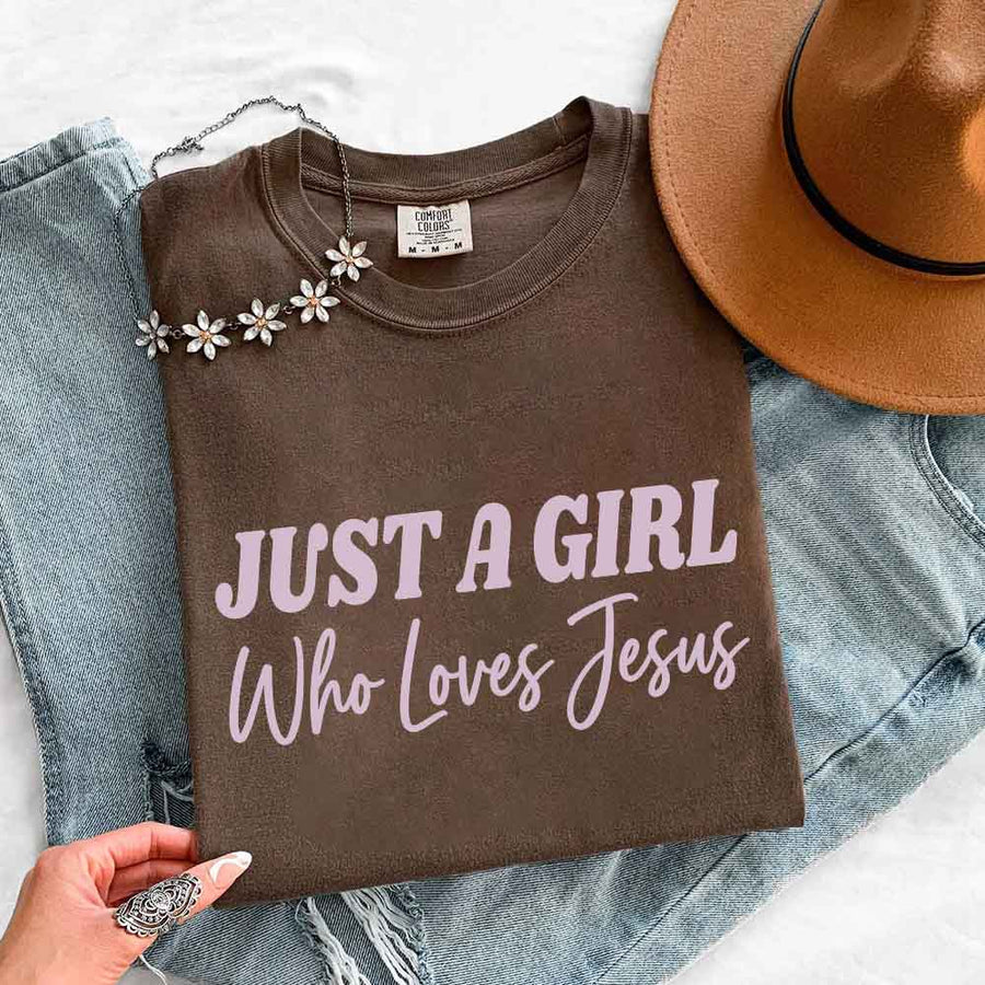 May include Just A Girl Who Loves Jesus Comfort Colors women’s faith graphic tee with relaxed fit design