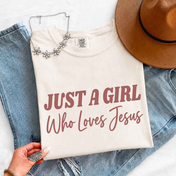 May include Just A Girl Who Loves Jesus Comfort Colors women’s faith graphic tee with relaxed fit design