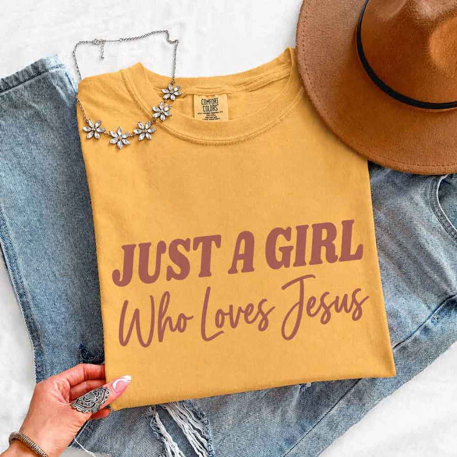 May include Just A Girl Who Loves Jesus Comfort Colors women’s faith graphic tee with relaxed fit design