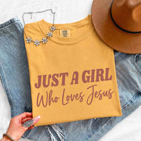 May include Just A Girl Who Loves Jesus Comfort Colors women’s faith graphic tee with relaxed fit design