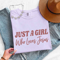 May include Just A Girl Who Loves Jesus Comfort Colors women’s faith graphic tee with relaxed fit design