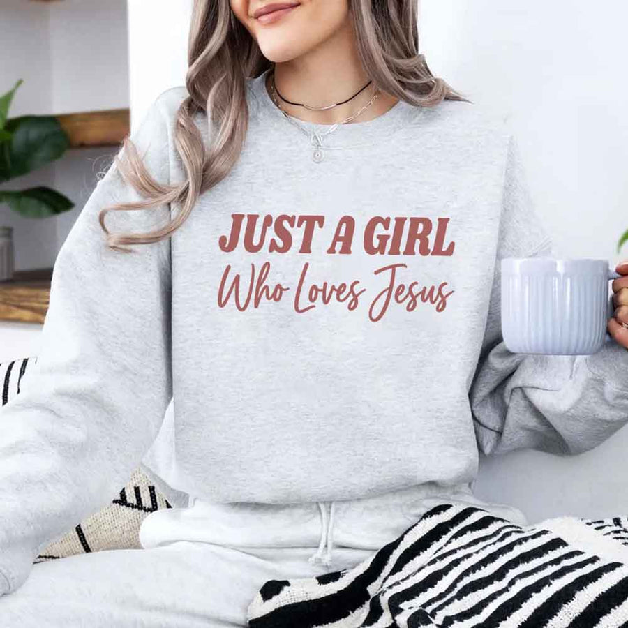 Just A Girl Who Loves Jesus sweatshirt with soft fabric, relaxed fit, and faith-based women’s design.