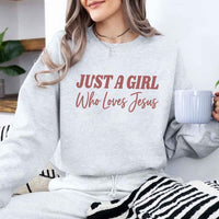 Just A Girl Who Loves Jesus sweatshirt with soft fabric, relaxed fit, and faith-based women’s design.