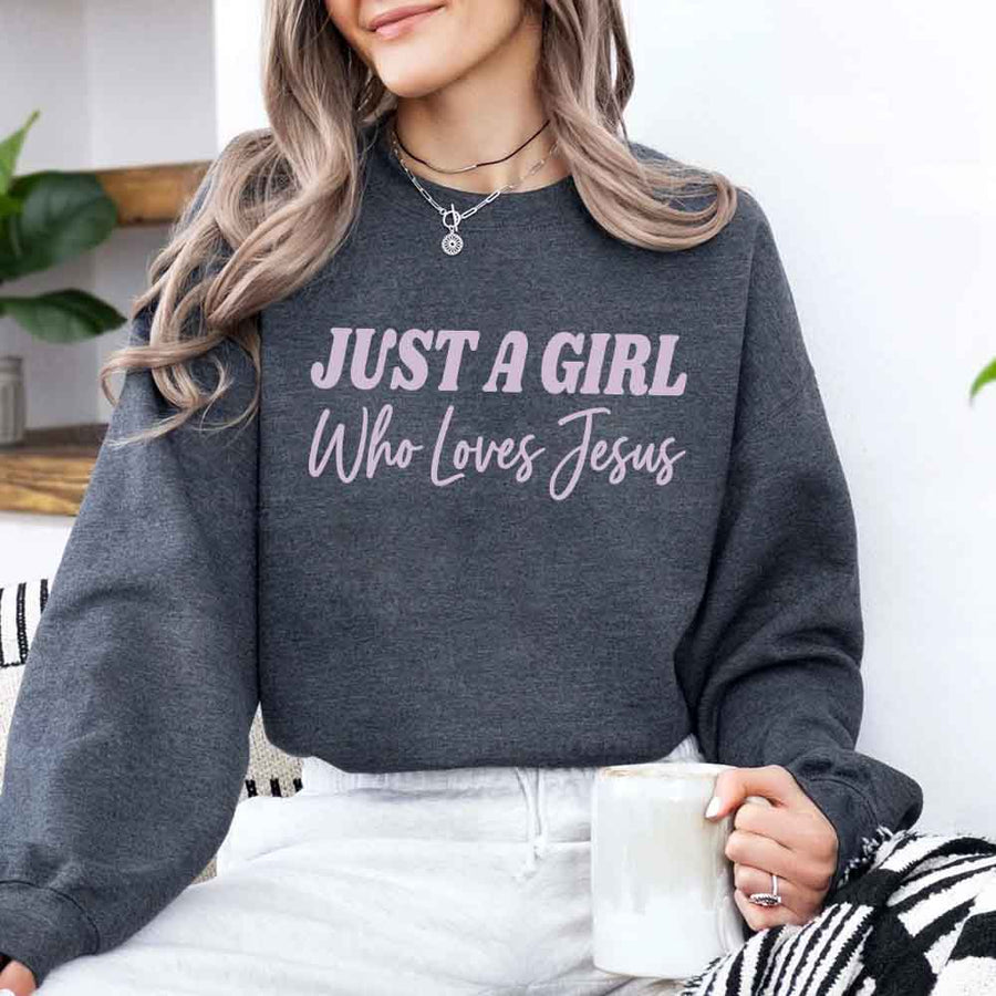 Just A Girl Who Loves Jesus sweatshirt with soft fabric, relaxed fit, and faith-based women’s design.