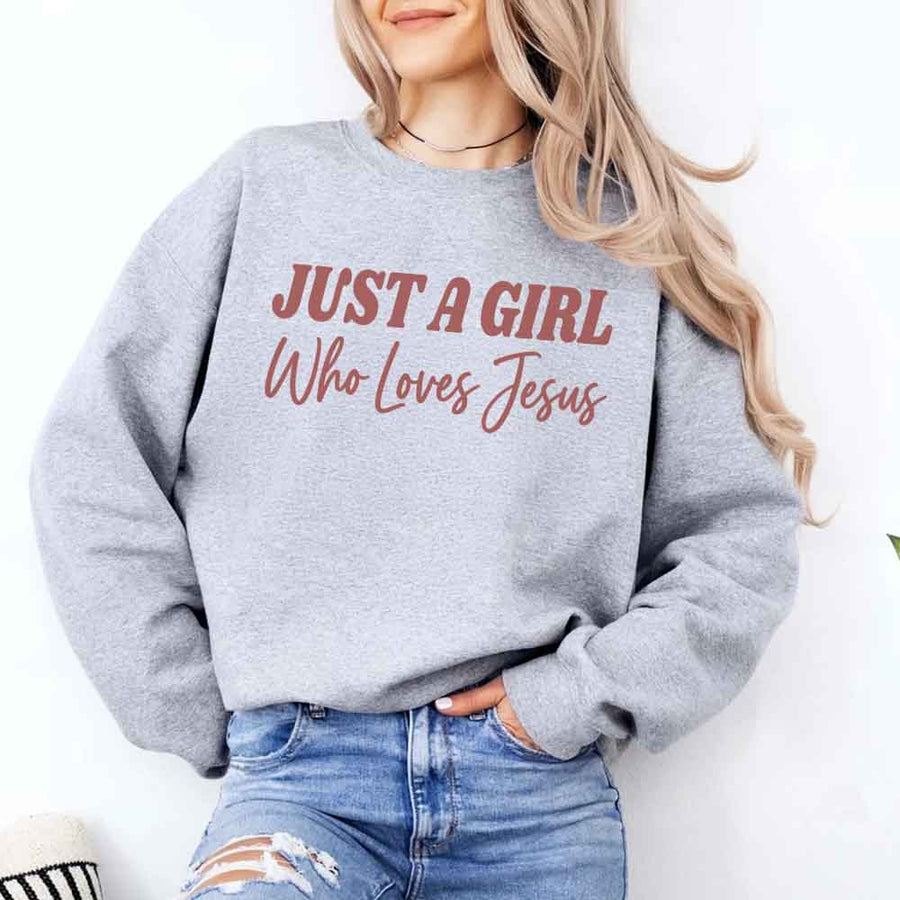 Just A Girl Who Loves Jesus sweatshirt with soft fabric, relaxed fit, and faith-based women’s design.