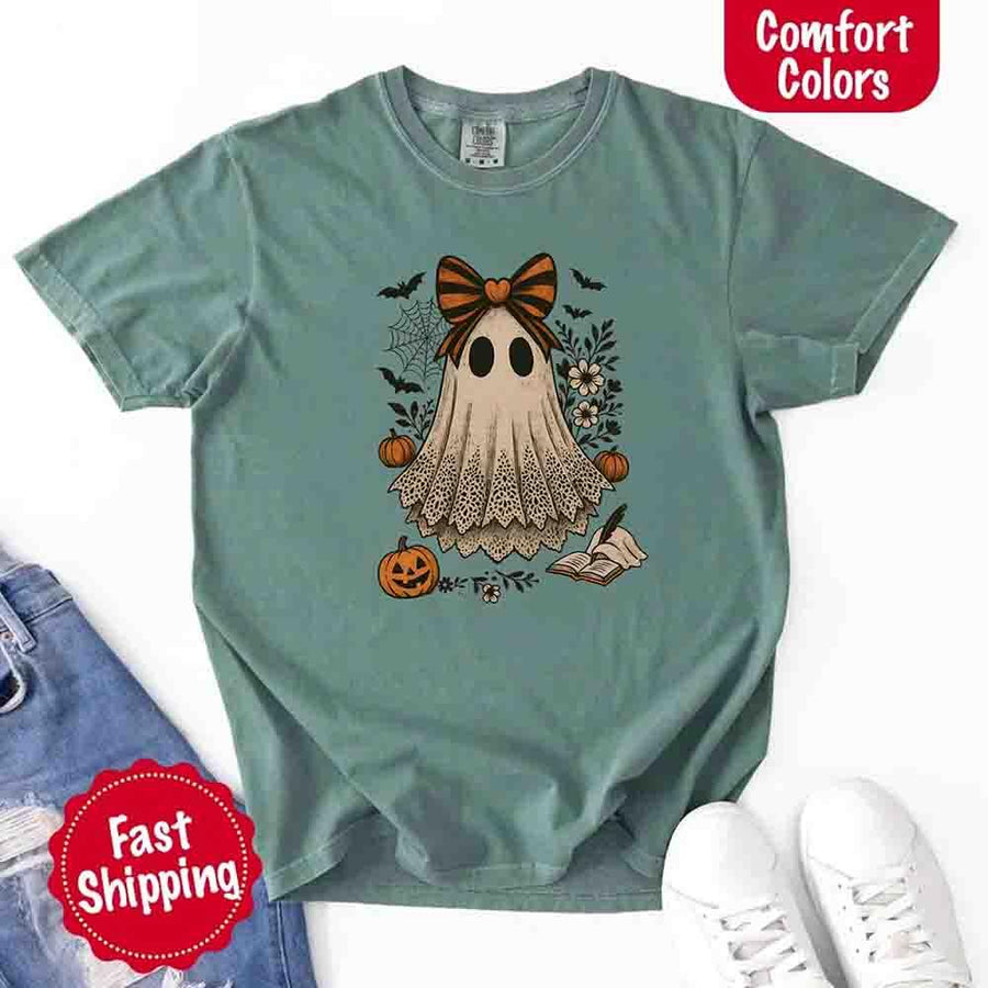 May include lace ghost Halloween graphic with black eyes, orange striped bow, pumpkins, spider web, bats, flowers, and open spell book – spooky vintage shirt design.