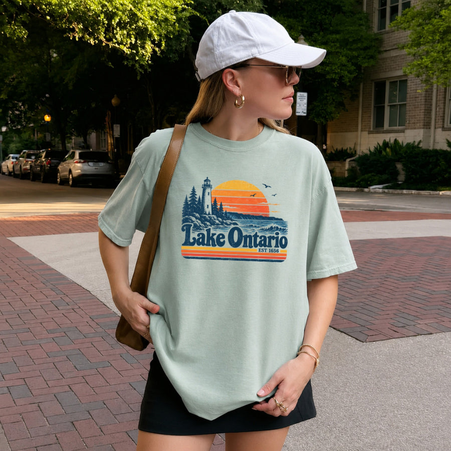 May include a Lake Ontario Comfort Colors T-Shirt featuring a lakeside-inspired graphic design for casual everyday wear.