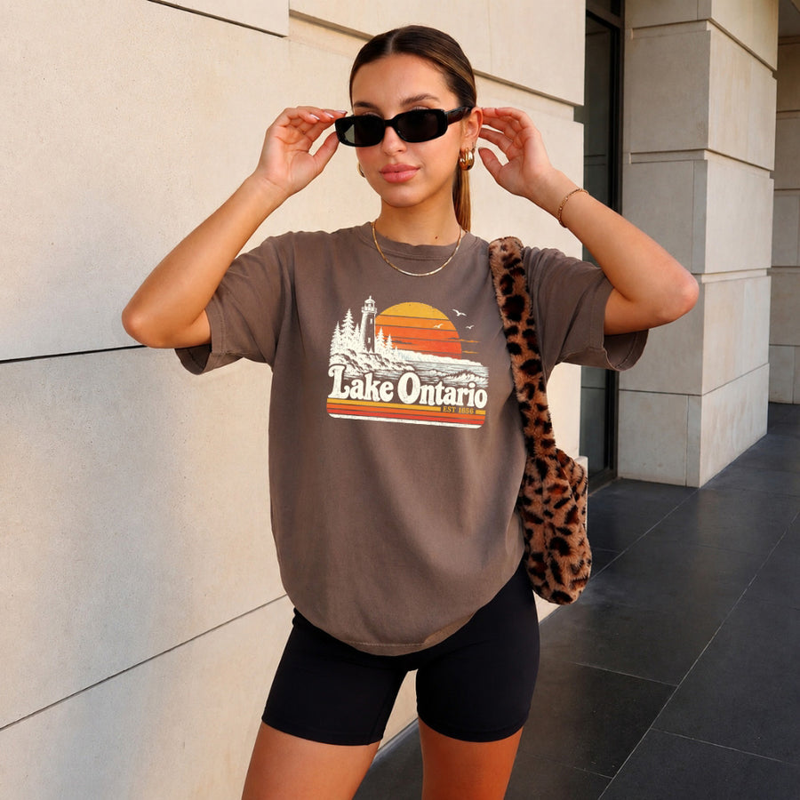 May include a Lake Ontario Comfort Colors T-Shirt featuring a lakeside-inspired graphic design for casual everyday wear.