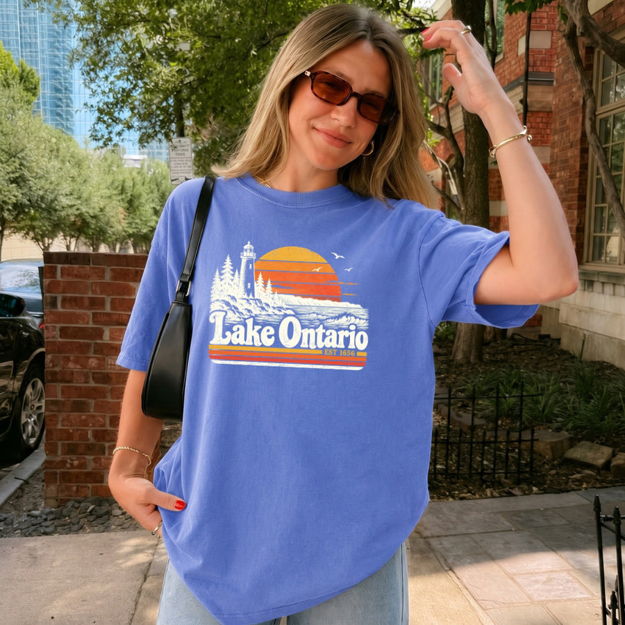 May include a Lake Ontario Comfort Colors T-Shirt featuring a lakeside-inspired graphic design for casual everyday wear.