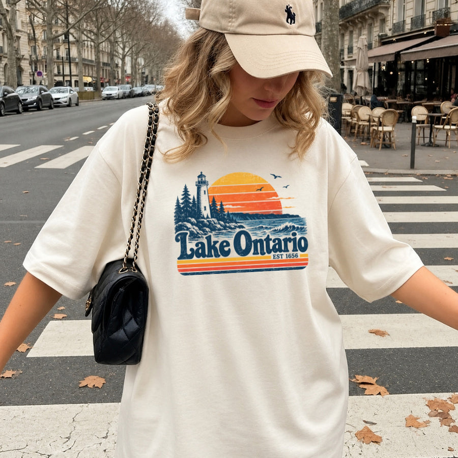 May include a Lake Ontario Comfort Colors T-Shirt featuring a lakeside-inspired graphic design for casual everyday wear.
