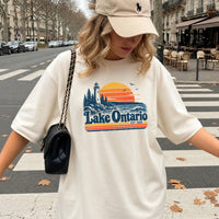 May include a Lake Ontario Comfort Colors T-Shirt featuring a lakeside-inspired graphic design for casual everyday wear.