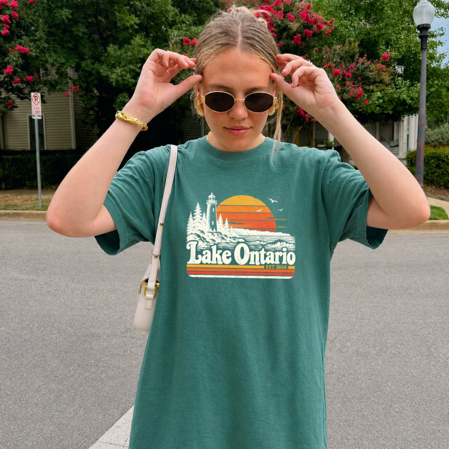 May include a Lake Ontario Comfort Colors T-Shirt featuring a lakeside-inspired graphic design for casual everyday wear.