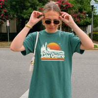 May include a Lake Ontario Comfort Colors T-Shirt featuring a lakeside-inspired graphic design for casual everyday wear.