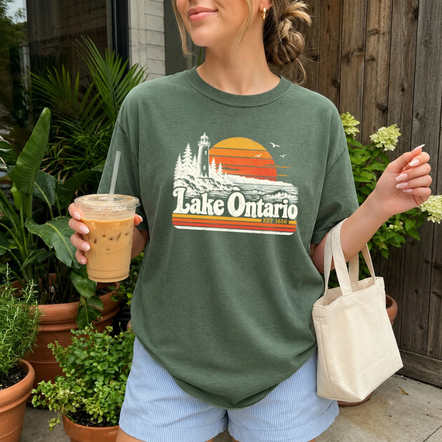 May include a Lake Ontario Comfort Colors T-Shirt featuring a lakeside-inspired graphic design for casual everyday wear.