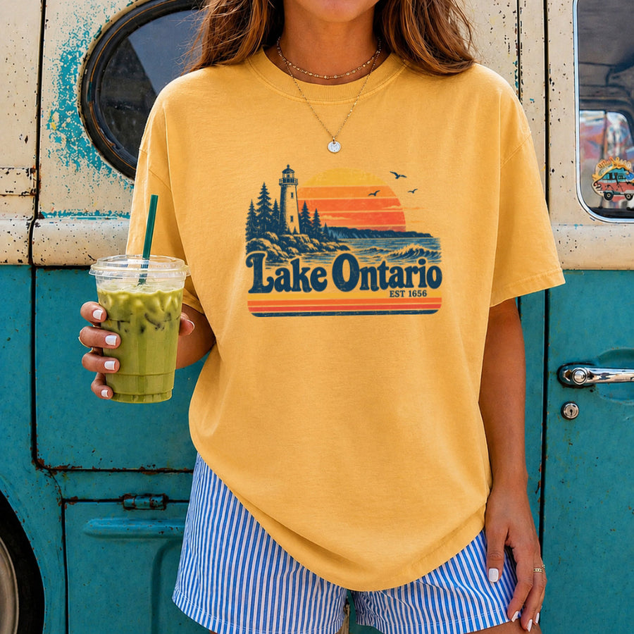 May include a Lake Ontario Comfort Colors T-Shirt featuring a lakeside-inspired graphic design for casual everyday wear.