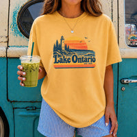 May include a Lake Ontario Comfort Colors T-Shirt featuring a lakeside-inspired graphic design for casual everyday wear.
