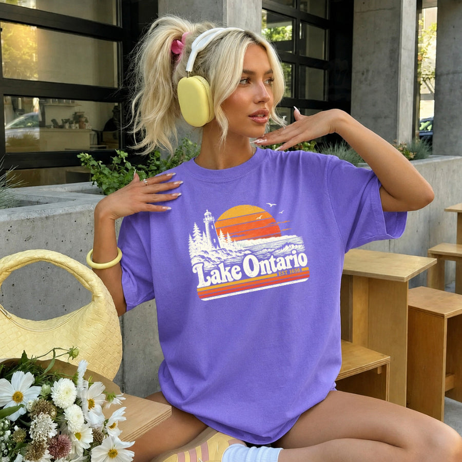 May include a Lake Ontario Comfort Colors T-Shirt featuring a lakeside-inspired graphic design for casual everyday wear.