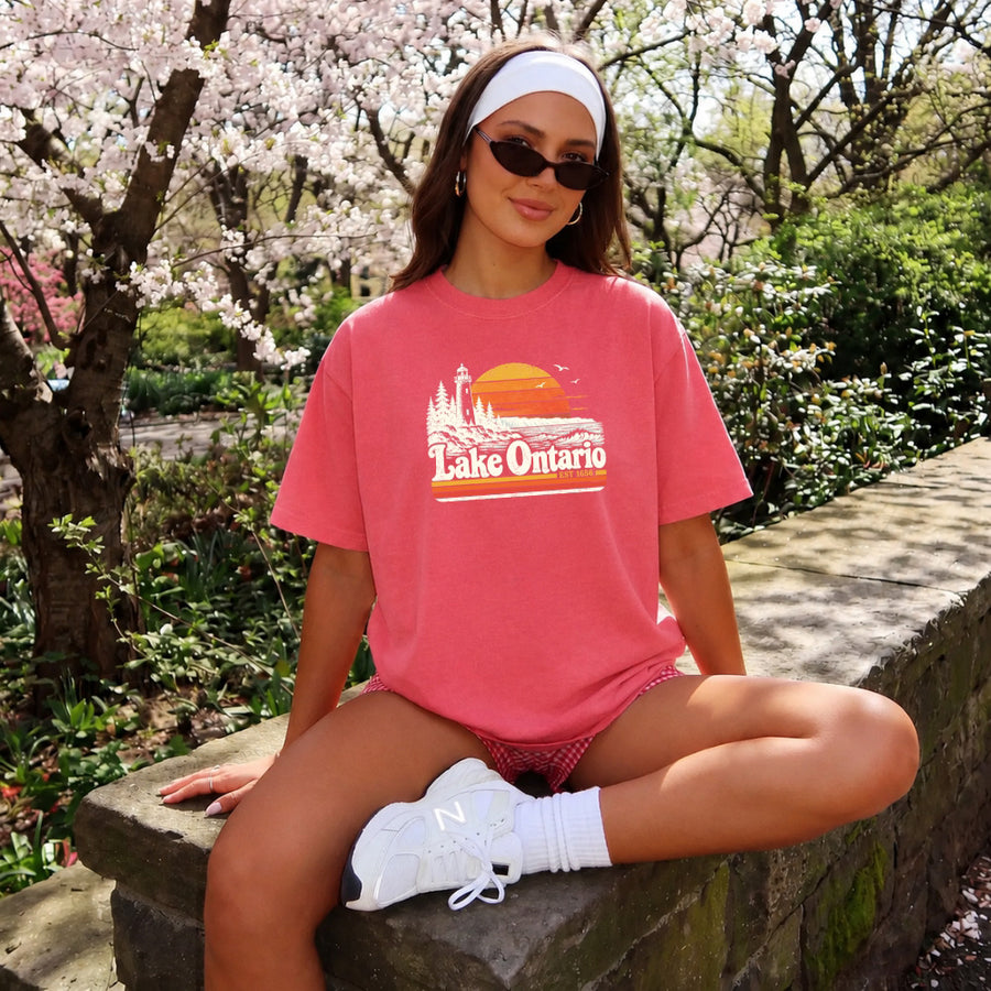 May include a Lake Ontario Comfort Colors T-Shirt featuring a lakeside-inspired graphic design for casual everyday wear.
