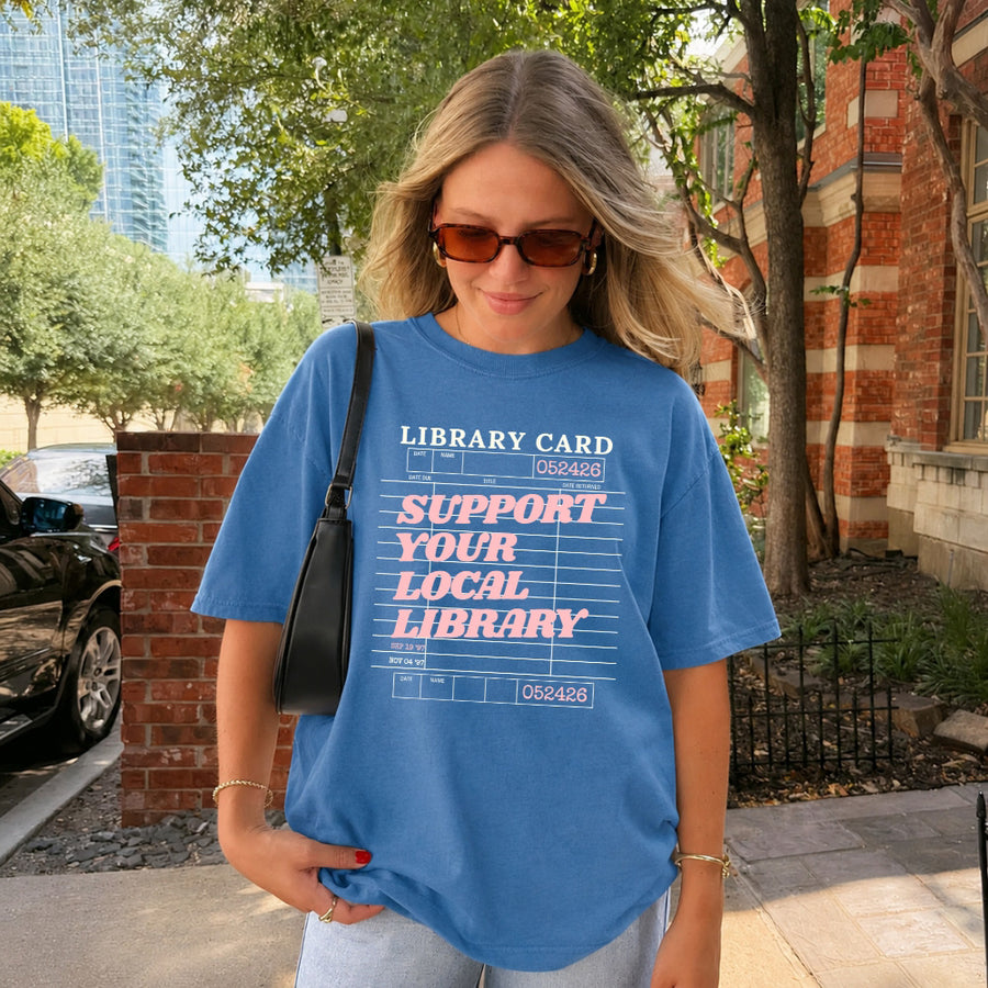 May include a Support Your Local Library Comfort Colors T-Shirt featuring a classic library-inspired statement design.