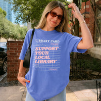 May include a Support Your Local Library Comfort Colors T-Shirt featuring a classic library-inspired statement design.