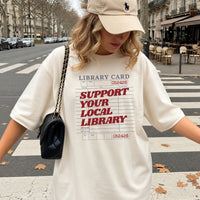 May include a Support Your Local Library Comfort Colors T-Shirt featuring a classic library-inspired statement design.