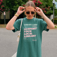 May include a Support Your Local Library Comfort Colors T-Shirt featuring a classic library-inspired statement design.