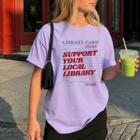May include a Support Your Local Library Comfort Colors T-Shirt featuring a classic library-inspired statement design.