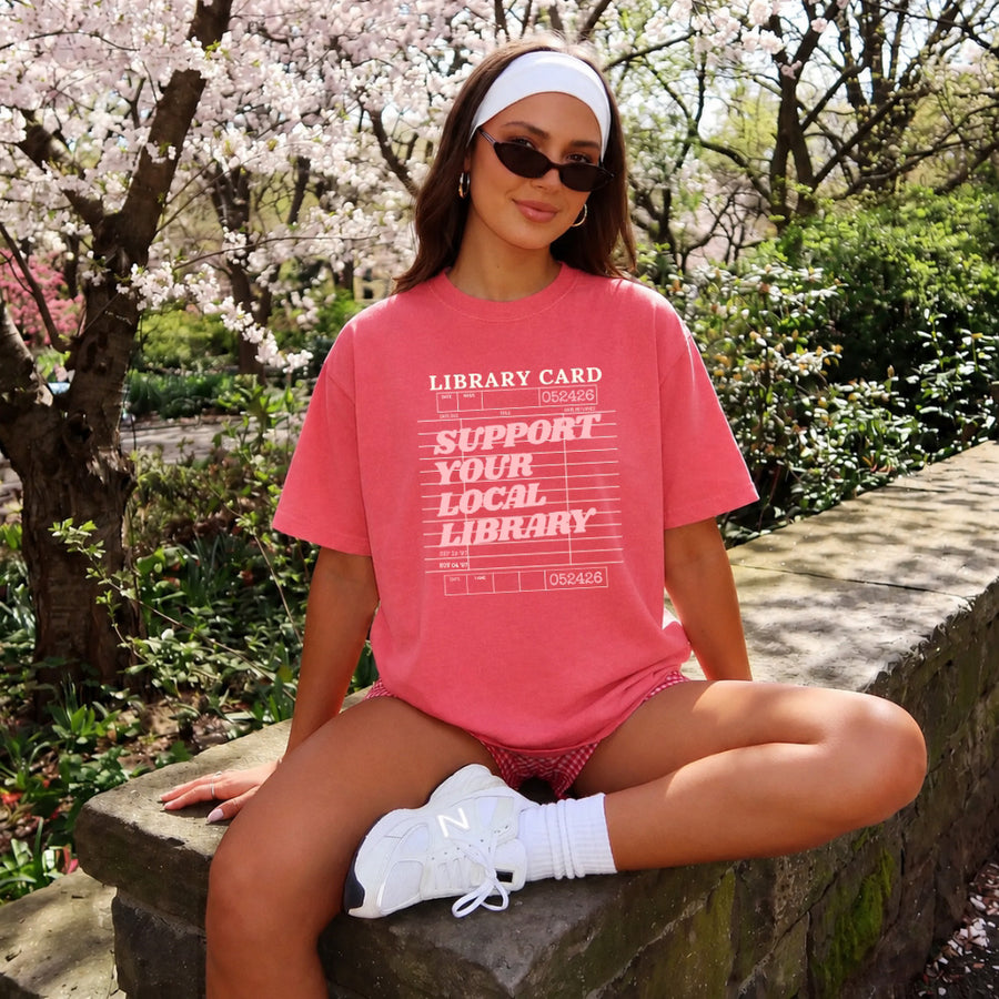 May include a Support Your Local Library Comfort Colors T-Shirt featuring a classic library-inspired statement design.