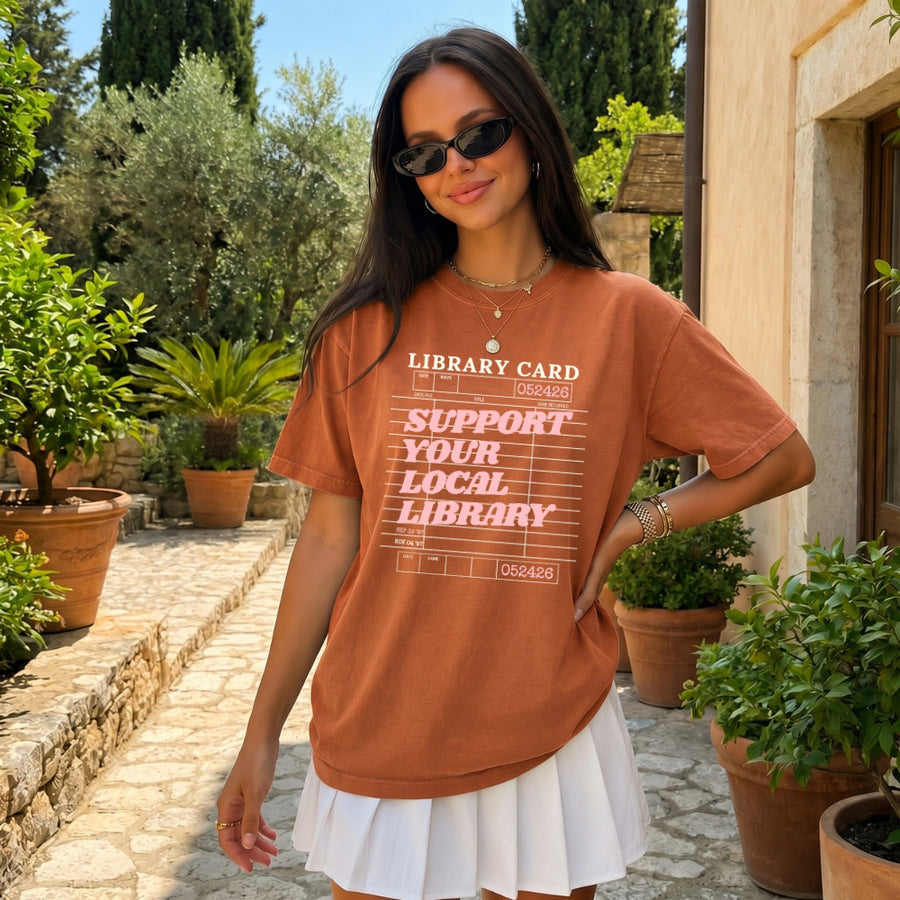 May include a Support Your Local Library Comfort Colors T-Shirt featuring a classic library-inspired statement design.