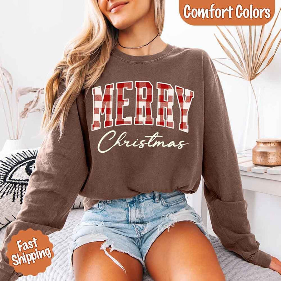 May include a Comfort Colors long sleeve or hoodie with a buffalo plaid “Merry Christmas” design for matching family outfits.