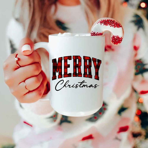 May include a ceramic mug with a buffalo plaid “Merry Christmas” design in traditional red and black tones.