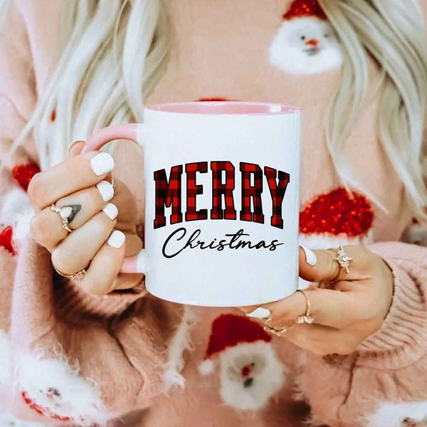 May include a ceramic mug with a buffalo plaid “Merry Christmas” design in traditional red and black tones.