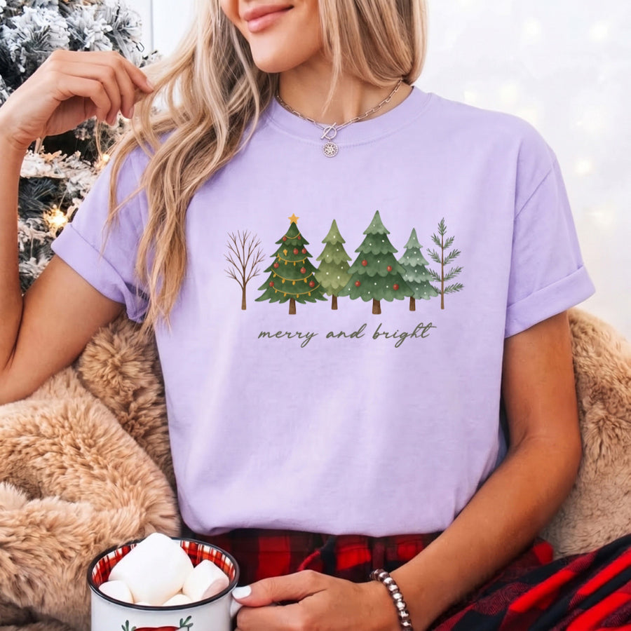 May include a Merry & Bright Christmas tree design on a Comfort Colors T-shirt, featuring a festive holiday theme perfect for Christmas gatherings, seasonal outfits, family celebrations, and gift giving.