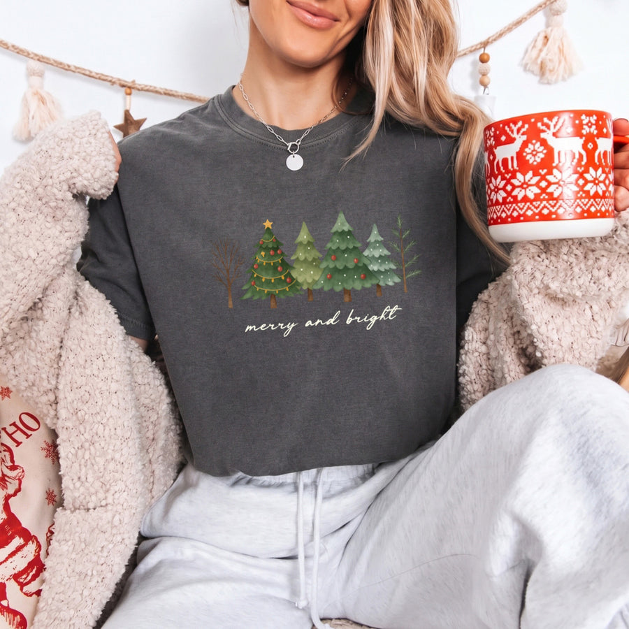 May include a Merry & Bright Christmas tree design on a Comfort Colors T-shirt, featuring a festive holiday theme perfect for Christmas gatherings, seasonal outfits, family celebrations, and gift giving.