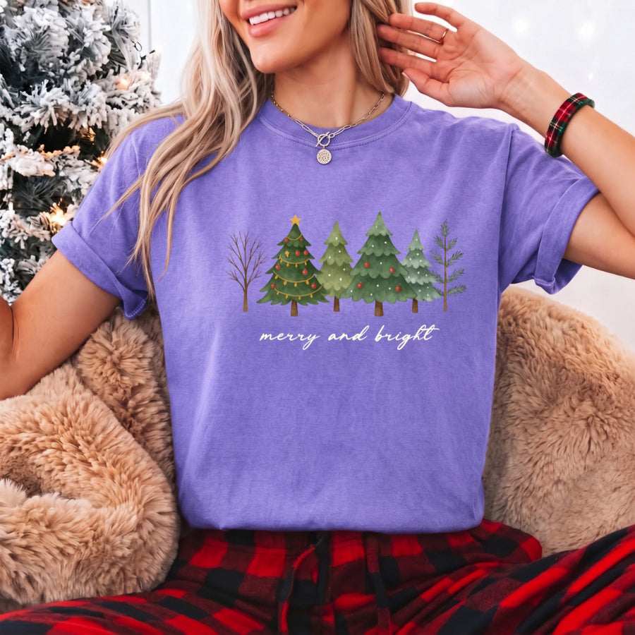 May include a Merry & Bright Christmas tree design on a Comfort Colors T-shirt, featuring a festive holiday theme perfect for Christmas gatherings, seasonal outfits, family celebrations, and gift giving.