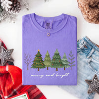 May include a Merry & Bright Christmas tree design on a Comfort Colors T-shirt, featuring a festive holiday theme perfect for Christmas gatherings, seasonal outfits, family celebrations, and gift giving.