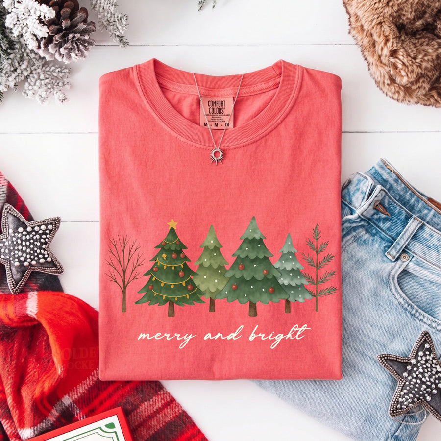 May include a Merry & Bright Christmas tree design on a Comfort Colors T-shirt, featuring a festive holiday theme perfect for Christmas gatherings, seasonal outfits, family celebrations, and gift giving.