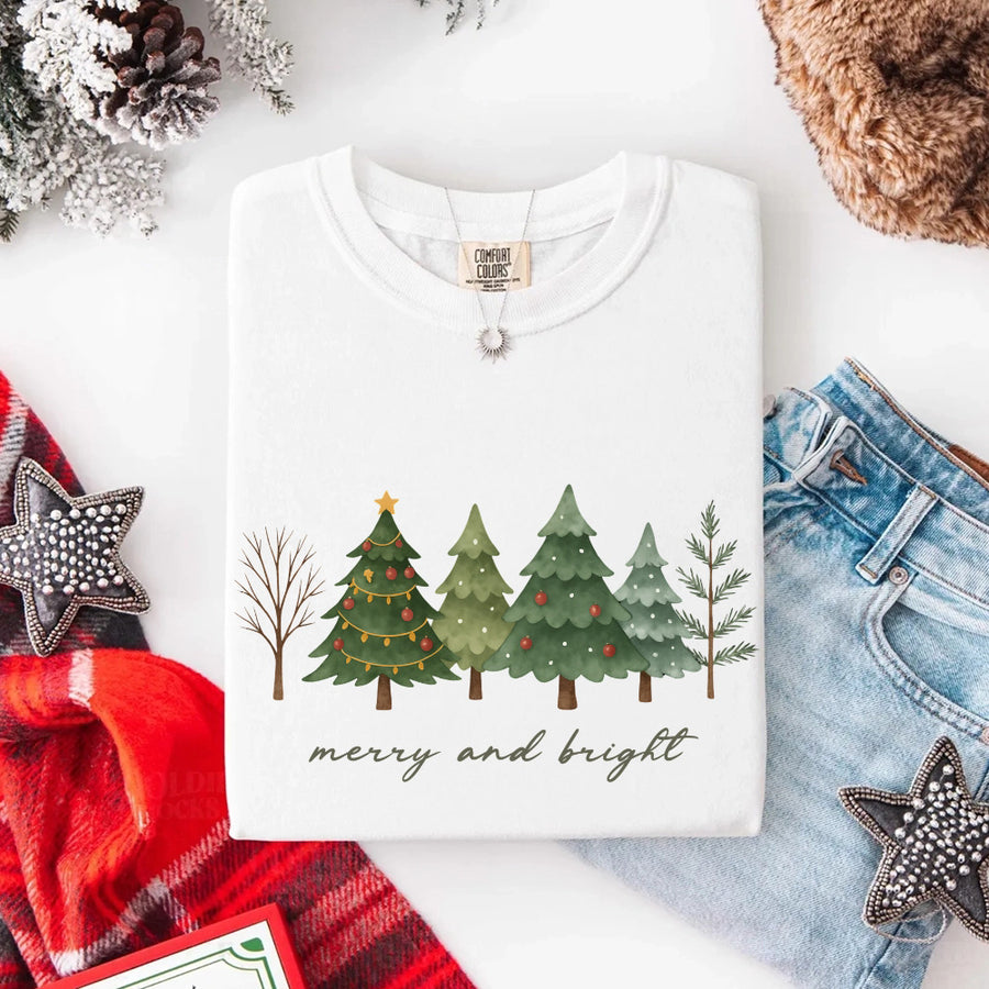 May include a Merry & Bright Christmas tree design on a Comfort Colors T-shirt, featuring a festive holiday theme perfect for Christmas gatherings, seasonal outfits, family celebrations, and gift giving.