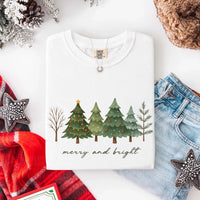 May include a Merry & Bright Christmas tree design on a Comfort Colors T-shirt, featuring a festive holiday theme perfect for Christmas gatherings, seasonal outfits, family celebrations, and gift giving.