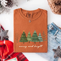 May include a Merry & Bright Christmas tree design on a Comfort Colors T-shirt, featuring a festive holiday theme perfect for Christmas gatherings, seasonal outfits, family celebrations, and gift giving.