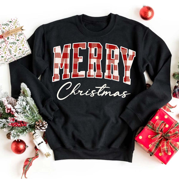 May include a close view of the words “Merry Christmas” printed on fabric, with the top word in a red and black buffalo plaid pattern and the script below in clean black lettering.