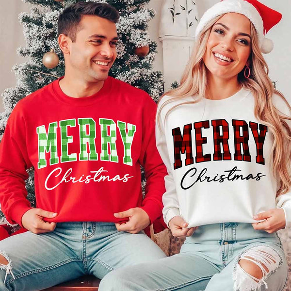 May include a close view of the words “Merry Christmas” printed on fabric, with the top word in a red and black buffalo plaid pattern and the script below in clean black lettering.