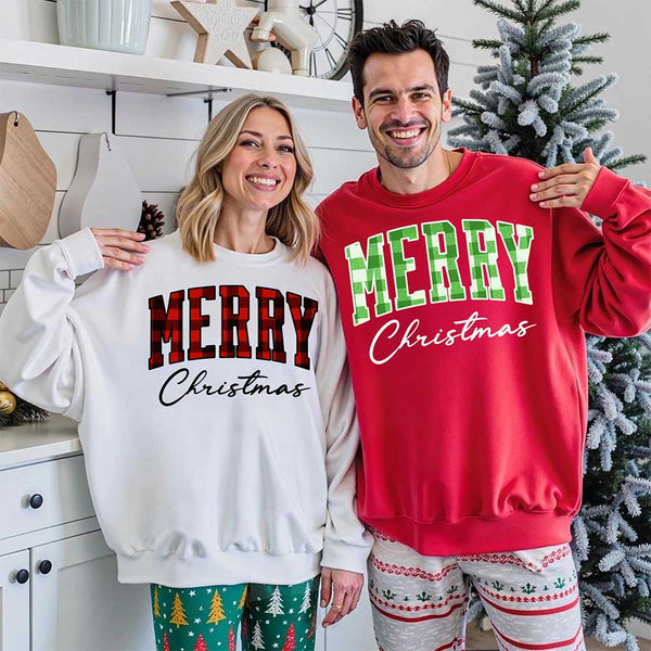 May include a close view of the words “Merry Christmas” printed on fabric, with the top word in a red and black buffalo plaid pattern and the script below in clean black lettering.